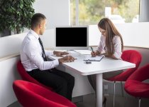 front-view-car-dealer-sellers-office-doing-paper-work-1-min.jpg